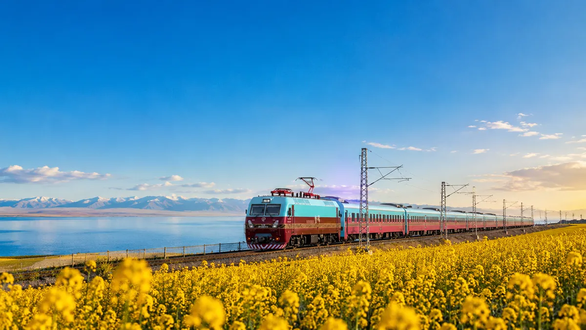 LuxurySilkRoadtrainpassingthroughyellowrapeseedfields.webp