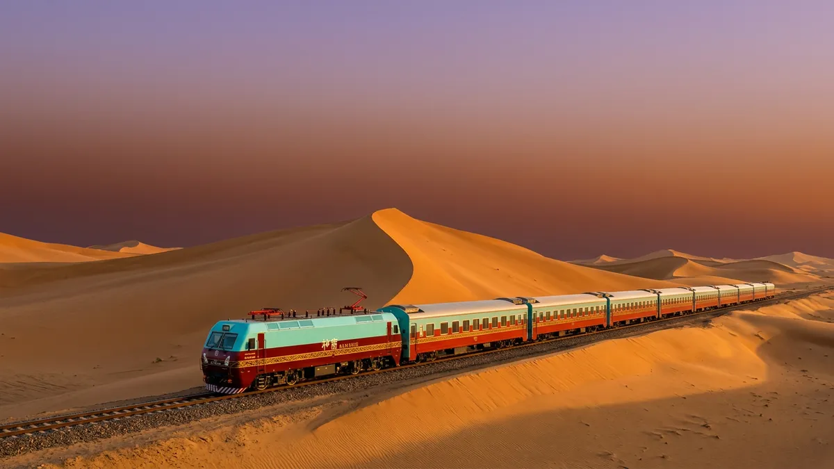 LuxuryvintageSilkRoadtraincrossinggoldendunesinDunhuangatsunsetbeneathavastgradientsky..webp